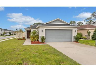 Charming single-story home with a well-manicured lawn and a spacious two-car garage at 600 Bullrush Ct, Davenport, FL 33837