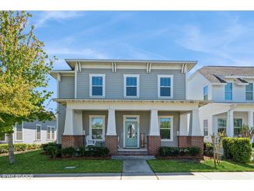 Charming two-story home with a welcoming front porch and manicured lawn at 985 Huntspoint St, Winter Garden, FL 34787