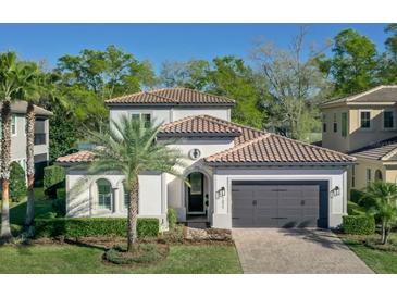Charming two-story home with a tile roof, manicured landscaping, and a two-car garage, showcasing its desirable curb appeal at 1377 Tappie Toorie Cir, Lake Mary, FL 32746
