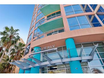 The Waverly's entrance with palm trees and modern architecture create an inviting arrival experience at 322 E Central Blvd # 606, Orlando, FL 32801