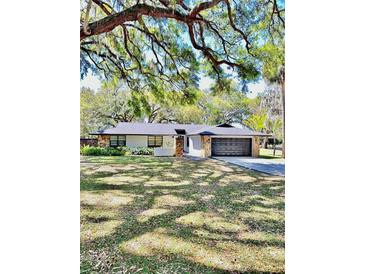 Charming single-story home featuring a two-car garage and elegant stone accents at 5374 Crooked Oak Cir, St Cloud, FL 34771