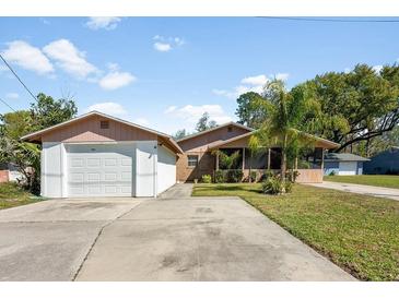 Charming single-story home featuring an attached two-car garage and a well-maintained front yard with mature landscaping at 6424 Jenny Dr, Lake Wales, FL 33898