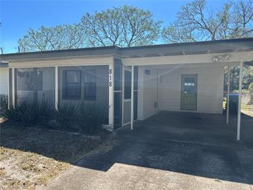 Charming single-story home with a covered carport, screened porch, and well-maintained front yard at 818 Logan Dr, Longwood, FL 32750