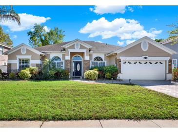 Charming single-story home featuring a well-manicured lawn, landscaping, and a two-car garage, offering great curb appeal at 929 Arbormoor Pl, Lake Mary, FL 32746