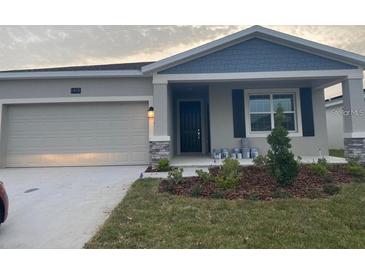 Charming single-Gathering home with a two-car garage, stone accents and a well-manicured lawn at 1418 Lassen St, Haines City, FL 33844