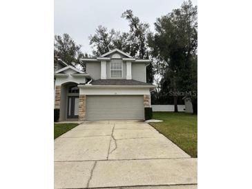 Well-maintained two-story home with a two-car garage and tidy front yard landscaping at 178 Chippendale Ter, Oviedo, FL 32765