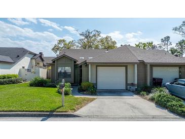 Charming single-story home featuring a well-maintained lawn and attached one car garage at 2696 Orange Peel Ct, Orlando, FL 32806