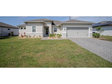 Charming single-story home featuring a well-manicured lawn, neutral paint, and a two-car garage at 2720 Bancroft Blvd, Orlando, FL 32833