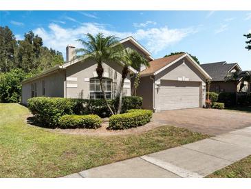 Charming single-story home with a two-car garage, well-manicured landscaping, and beautiful palm trees at 3655 Seminole Dr, Orlando, FL 32812