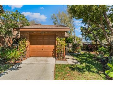 Attached one-car garage with well-maintained landscaping at 3901 Villas Green Cir # 1, Longwood, FL 32779