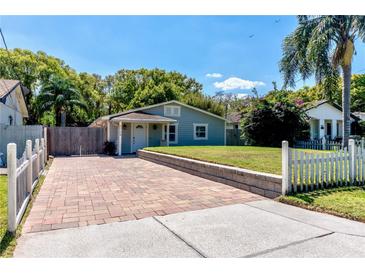 Charming home with beautiful brick driveway, manicured lawn, and lush landscaping at 5108 Sunrise Blvd, Orlando, FL 32803