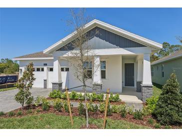 Charming single-story home featuring a neatly landscaped front yard, two-car garage and covered front porch at 8007 Colby Cir, Orlando, FL 32817