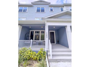 Charming two-story townhome featuring a cozy porch and well-maintained landscaping at 1284 Spotted Sandpiper Loop, Winter Springs, FL 32708