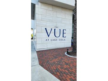 A closer view of The Vue at Lake Eola brick sign with palm tree near the building's corner at 150 E Robinson St # 12A-15 / 1216, Orlando, FL 32801