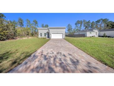 Beautiful new construction home featuring a brick driveway and a two-car garage at 17135 Sw 41 Ct, Ocala, FL 34473