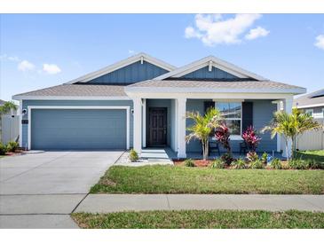 Charming single-story home with a well-maintained lawn and a welcoming front porch at 429 N Andrea Cir, Haines City, FL 33844