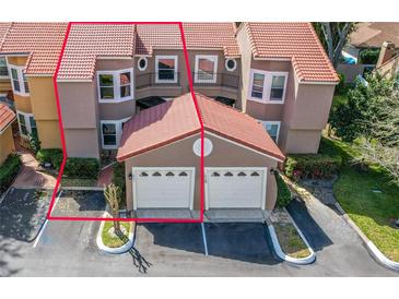 This exterior elevation shows an attached townhome with a tile roof, two-car garage, and manicured landscaping at 995 Casa Del Sol Cir, Altamonte Springs, FL 32714