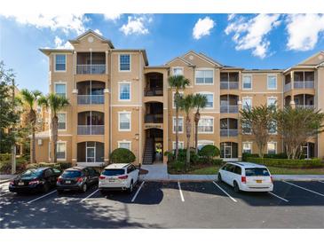 Beautiful three-story condo building with beige exterior and well-maintained landscaping at 2784 Almaton Loop # 301, Kissimmee, FL 34747