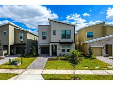 Beautiful contemporary two-story home with modern design, landscaping, and inviting curb appeal at 2807 Bookmark Dr, Kissimmee, FL 34746