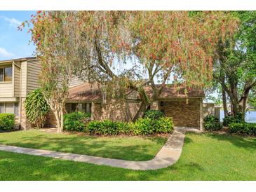 Charming single-story brick home with mature landscaping and a beautiful flowering tree at 409 Oak Haven Dr # 409, Altamonte Springs, FL 32701