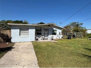 Charming single-story home with a well-maintained front yard and a concrete driveway at 655 Katherine Ave, Orlando, FL 32810