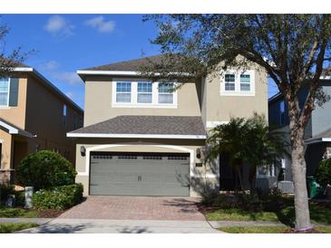 Charming two-story home with a two-car garage and well-maintained landscaping at 7609 Brookhurst Ln, Kissimmee, FL 34747