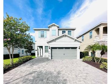 Charming two-story home with a well-manicured lawn, beautiful landscaping, and a spacious driveway at 7719 Graben St, Kissimmee, FL 34747