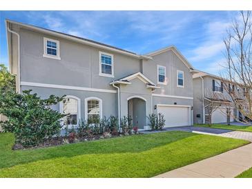 Charming two-story home featuring a landscaped yard and attached garage, ideal for Gathering living at 965 Talon Pl, Winter Springs, FL 32708