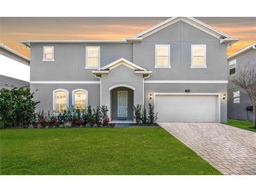 Charming two-story home features a well-manicured lawn, an attached two car garage, and a welcoming front entrance at 965 Talon Pl, Winter Springs, FL 32708