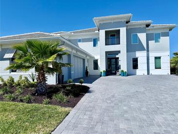Imposing modern two-story home featuring a paved driveway and verdant front lawn at 10032 Brocksport Cir, Gotha, FL 34734