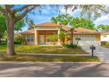 Charming single-story home with a well-maintained front yard, mature trees, and a two-car garage at 1187 Tadsworth Ter, Lake Mary, FL 32746