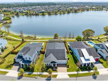 Stunning aerial view of waterfront homes, showcasing pools and lake access at 13059 Stoddart Ave, Orlando, FL 32827