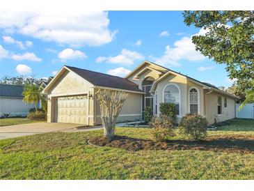 Charming single-story home featuring a well-manicured lawn and an attached two-car garage at 1600 Riveredge Rd, Oviedo, FL 32766