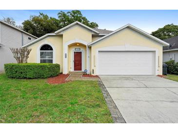 Charming single-story home with a well-manicured lawn and a two-car garage at 1669 Slash Pine Pl, Oviedo, FL 32765