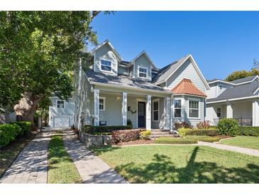 Charming two-story home with landscaped yard, stone driveway, copper awning and covered porch in a quiet neighborhood at 2109 E Central Blvd, Orlando, FL 32803