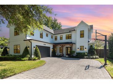Beautiful two-story home featuring a basketball hoop and lush landscaping at 2536 Brookshire Ave, Winter Park, FL 32792