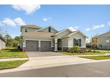 Charming two-story home with a two-car garage and well-manicured lawn on a sunny day at 737 Hyperion Dr, Debary, FL 32713