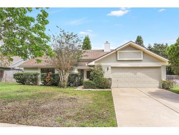 Charming single-Gathering home with a two-car garage and well-maintained front yard landscaping at 1072 Weaver Dr, Oviedo, FL 32765