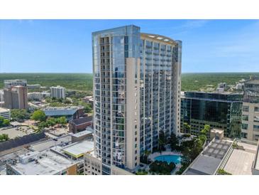 Stunning high-rise condominium showcasing modern architecture, a pool, and city views at 155 S Court Ave # 1613, Orlando, FL 32801