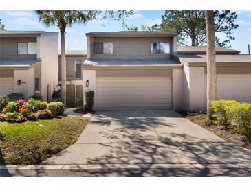 Charming townhouse featuring a two-car garage and beautiful landscaping in a well-maintained community at 643 Woodridge Dr, Fern Park, FL 32730