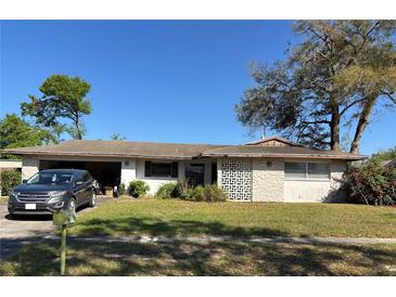 Charming single-story home featuring a well-maintained front yard and a car in the driveway at 209 Whippoorwill Dr, Altamonte Springs, FL 32701