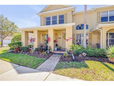 Inviting two-story townhome with a well-manicured lawn and colorful landscaping at 3621 Casello Dr, New Smyrna Beach, FL 32168
