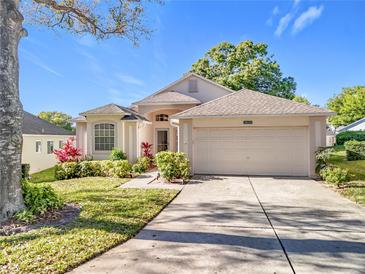 Charming single-story home with a two-car garage and beautiful landscaping, perfect for a Gathering at 3635 Kingswood Ct, Clermont, FL 34711