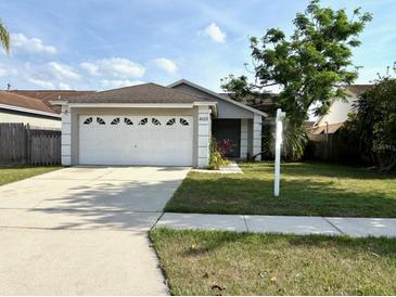 Charming single-story home with a well-manicured lawn and attached two-car garage at 4618 Prairie Point, Kissimmee, FL 34746