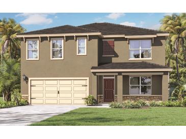 Two-story home featuring a two-car garage, neutral colored stucco exterior, and lush landscaping at 5215 Ligonberry St, Lakeland, FL 33811