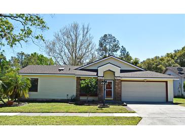 Charming single Gathering home with well-maintained lawn and attached two car garage on a clear sunny day at 691 Monroe Harbor Pl, Sanford, FL 32773
