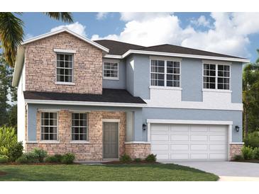 Charming two-story home with stone accents, blue siding and an attached two-car garage at 9560 Starling Loop, Leesburg, FL 34788