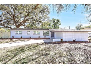 Charming single-story home with freshly painted white exterior and beautiful landscaping at 3434 Se 12Th St, Ocala, FL 34471