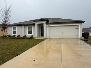 Charming single-story home featuring a two-car garage and well-maintained landscaping at 439 Mulberry Ct, Kissimmee, FL 34759