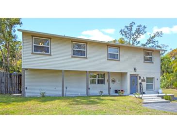 Charming two-story home with neutral siding, a covered porch, and a well-manicured lawn at 500 Forest Lake Dr, Altamonte Springs, FL 32714
